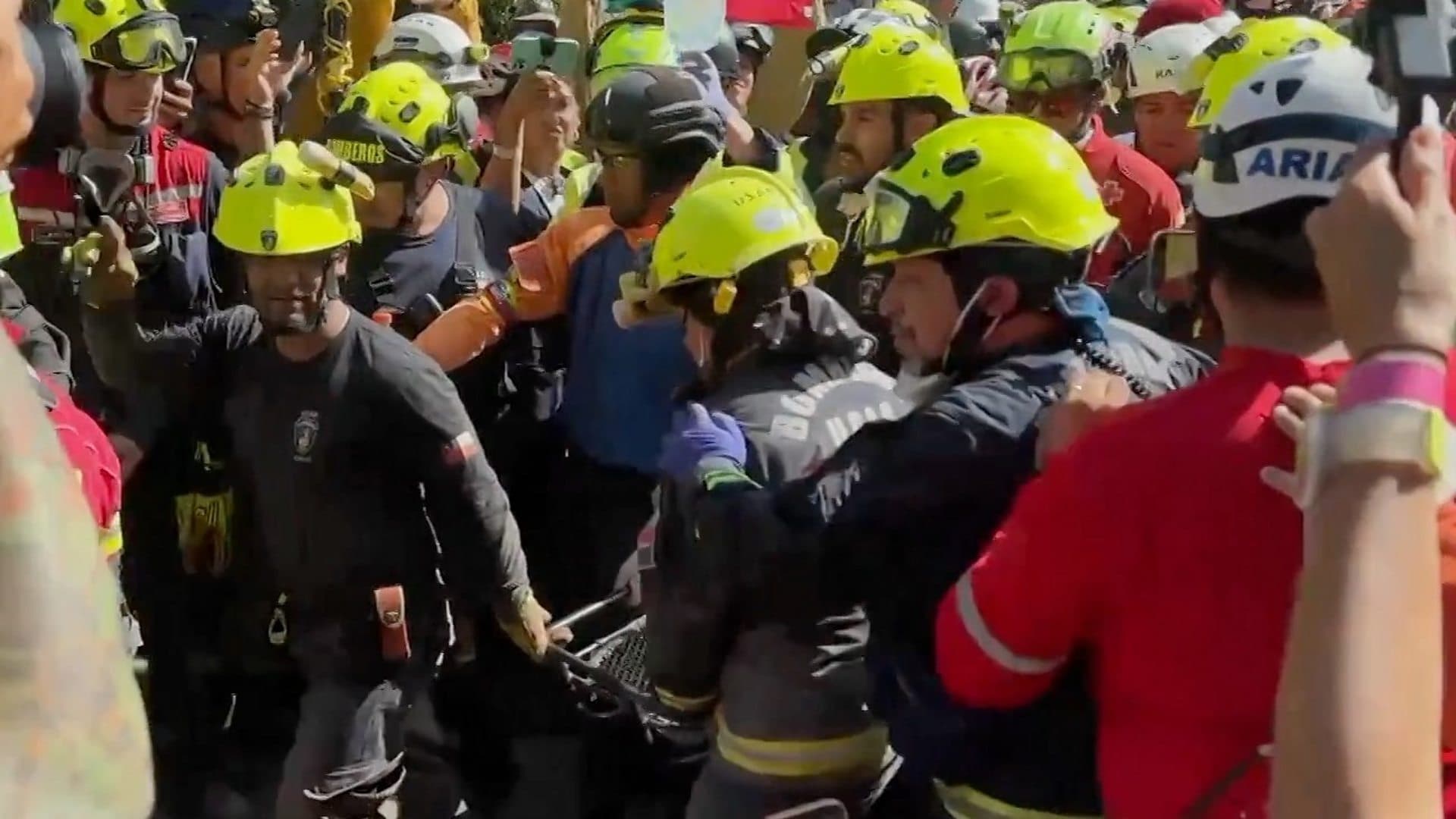 Cheers and applause as security guard rescued from rubble
